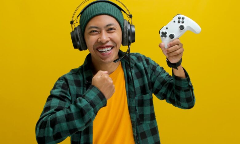 A man wearing headphones and holding a video game controller