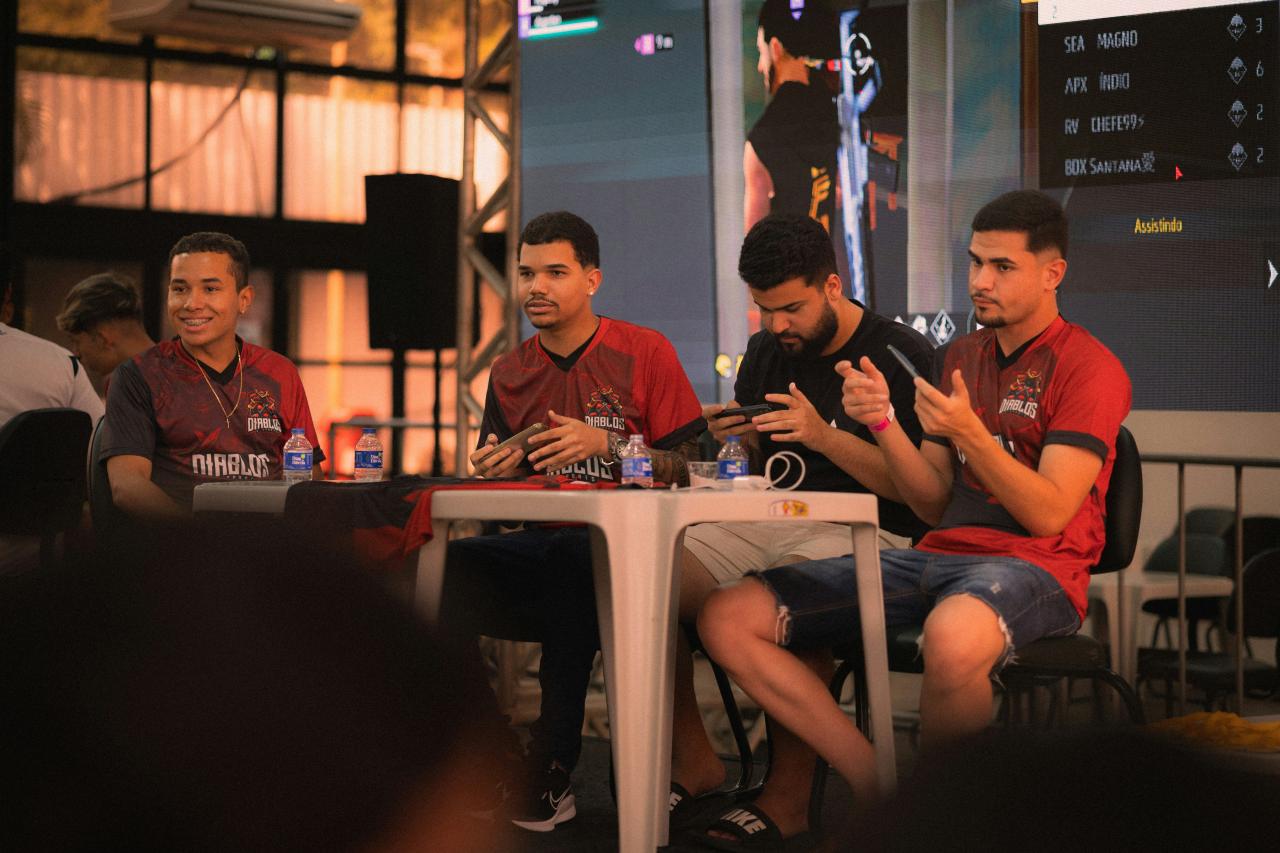 Four men sitting at a table during an event.