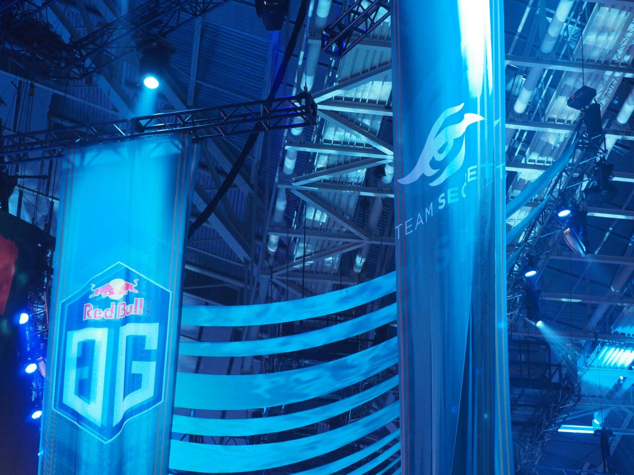 Blue banners with team logos at an esports event