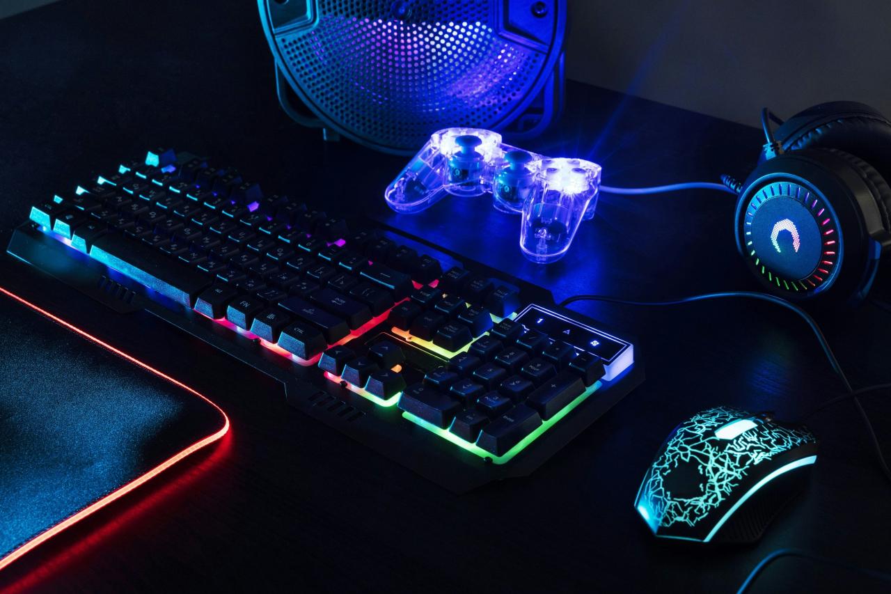 a computer keyboard, mouse, and headphones on a desk