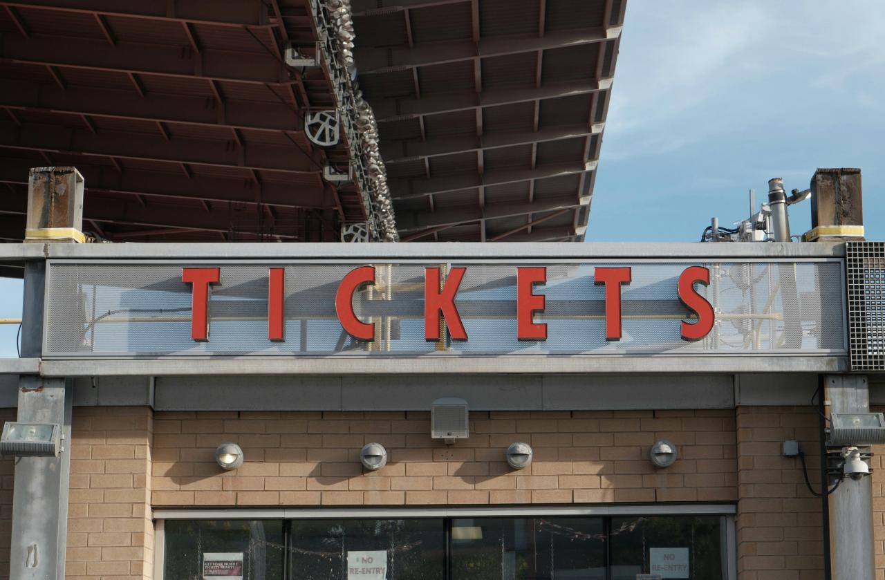 Red letters spell tickets above a building entrance